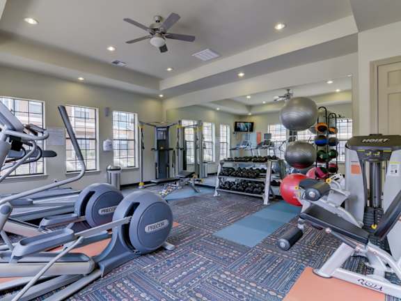 A spacious home gym with a variety of exercise equipment.