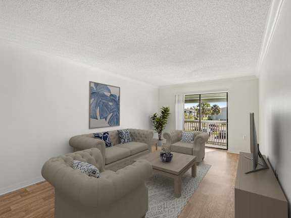 A living room with a couch, a coffee table, and a painting on the wall.