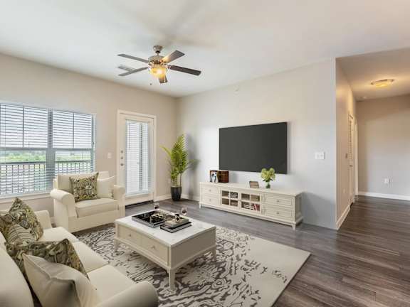 A living room with a white couch and a coffee table.