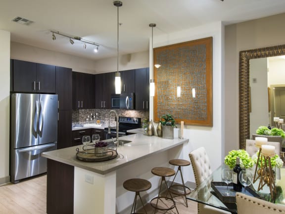 a kitchen with stainless steel appliances and granite countertops