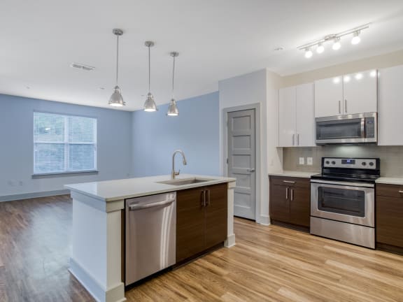 a kitchen with stainless steel appliances and granite countertops