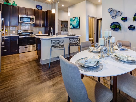 a kitchen with stainless steel appliances and granite countertops