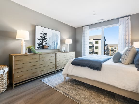 a bedroom with a bed and a dresser and a window at Stonehill at West Orange, West Orange, New Jersey