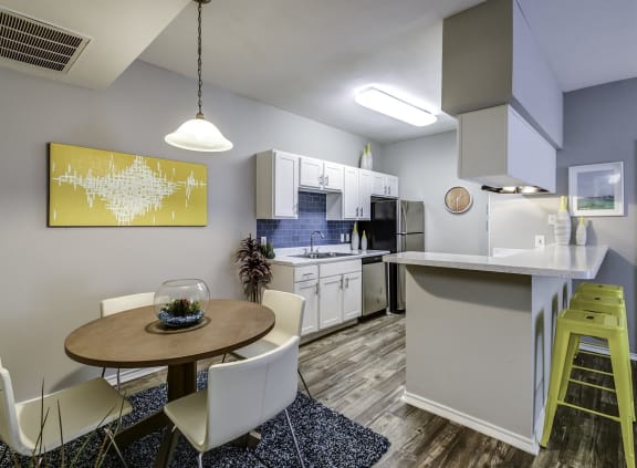 a living room and kitchen with a blue couch
