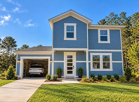 A blue house with a white garage door.