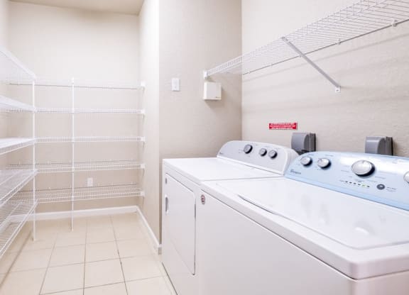 a washer and dryer in a laundry room with a closet at Linden on the GreeneWay, Florida