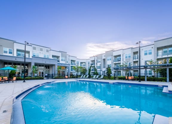 a large swimming pool in front of an apartment building at Linden on the GreeneWay, Florida
