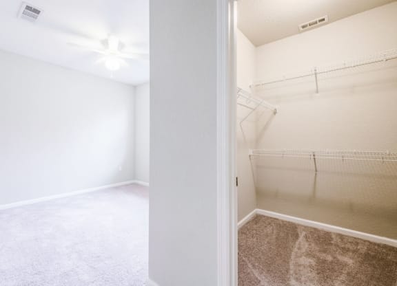 an empty bedroom with a mirrored closet and a ceiling fan at Linden on the GreeneWay, Florida