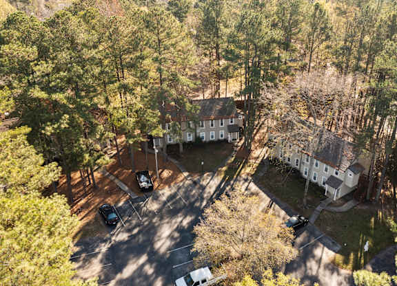 A bird's eye view of a house surrounded by trees at West Oak Apartments, North Carolina 27587
