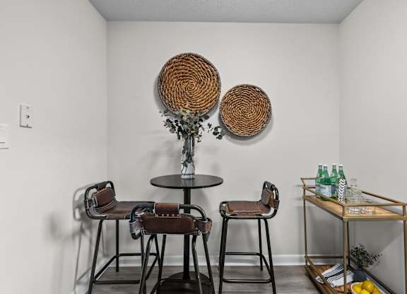 A white room with a round table and two chairs at West Oak Apartments, Wake Forest, North Carolina