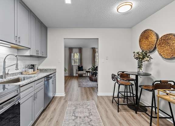 A kitchen with a dining table and chairs at West Oak Apartments, Wake Forest, NC 27587