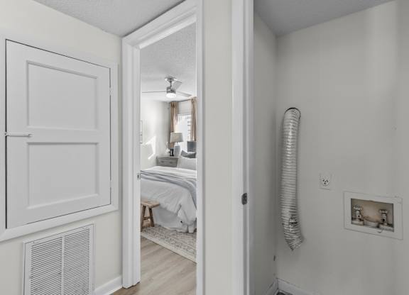 A white room with a bed and a window at West Oak Apartments, Wake Forest, NC