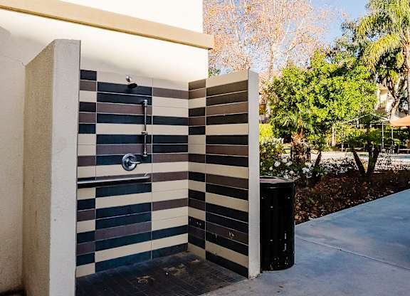 A shower with a black and white tiled wall. at Legends at Rancho Belago, Moreno Valley