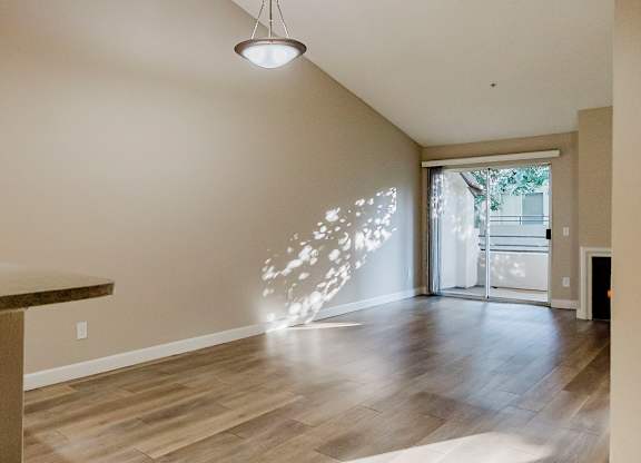 A room with a wooden floor and a ceiling light. at Legends at Rancho Belago, Moreno Valley, California