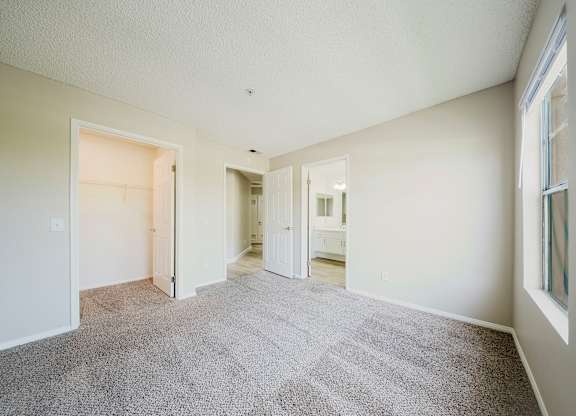 A spacious room with carpeted floor and white walls. at Legends at Rancho Belago, Moreno Valley, 92553
