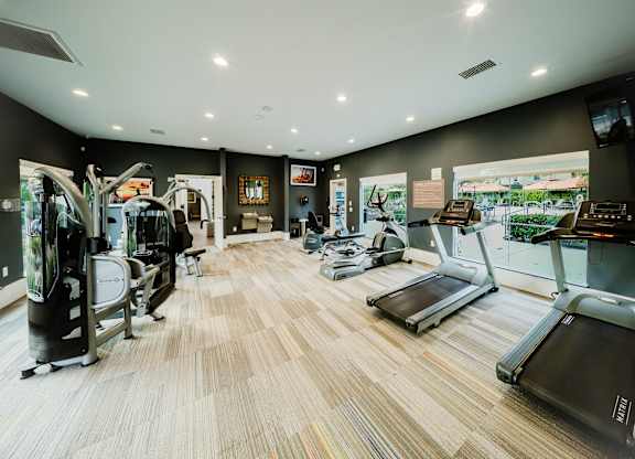 A gym with treadmilers, weights, and exercise equipment. at Legends at Rancho Belago, Moreno Valley, 92553