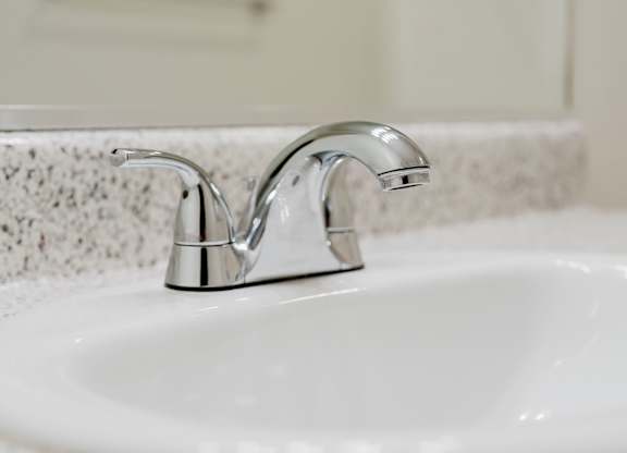 A white sink with a chrome faucet. at Legends at Rancho Belago, Moreno Valley, 92553