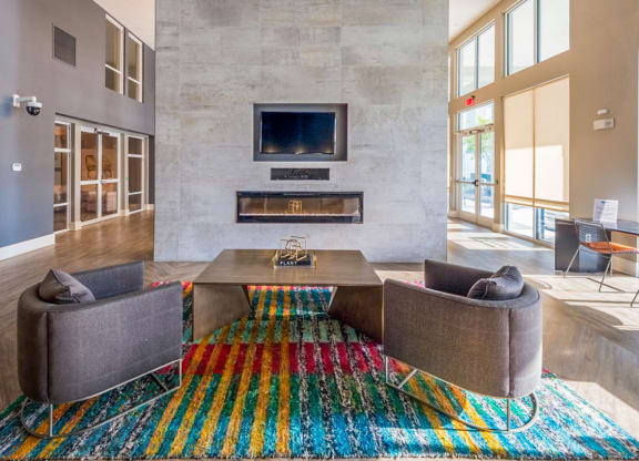 a living room with couches and a table and a fireplace at Linden on the GreeneWay, Florida, 32824