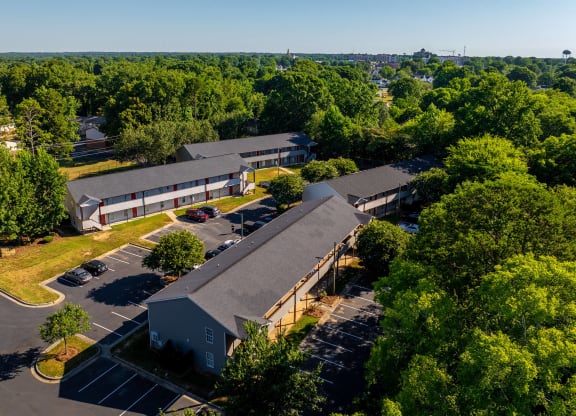 a view from above of a building with a parking lot and trees at Ashford Place Apartments, Kannapolis, NC 28081
