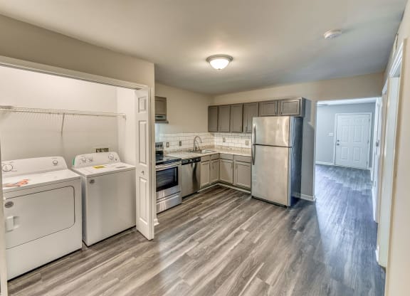 a kitchen with white appliances and stainless steel appliances at Ashford Place Apartments, North Carolina, 28081