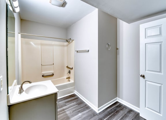 a bathroom with a sink and a mirror and a shower at Ashford Place Apartments, North Carolina