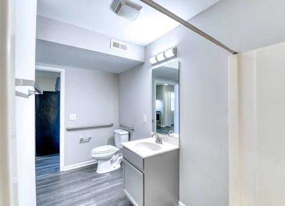 a bathroom with a sink and a toilet and a mirror at Ashford Place Apartments, Kannapolis North Carolina 