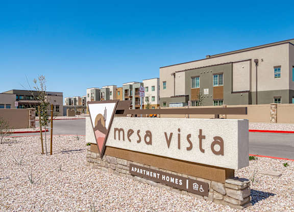 A sign for Mesa Vista Apartment Homes is in front of a building.
