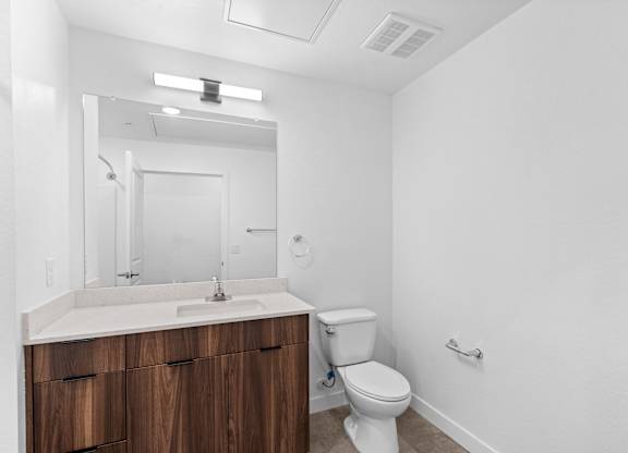 A white bathroom with a toilet and sink.