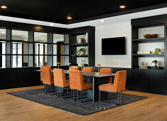 A black and white dining room with a table and chairs.