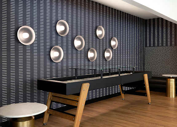 A black and white room with a long table and chairs.