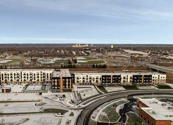 A large building complex with a circular driveway in front.