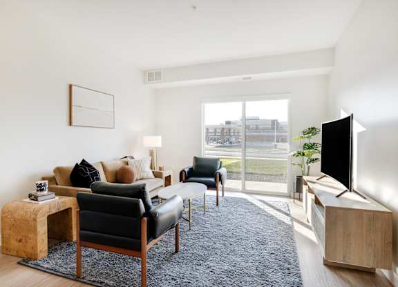 A living room with a black leather chair and a wooden side table.