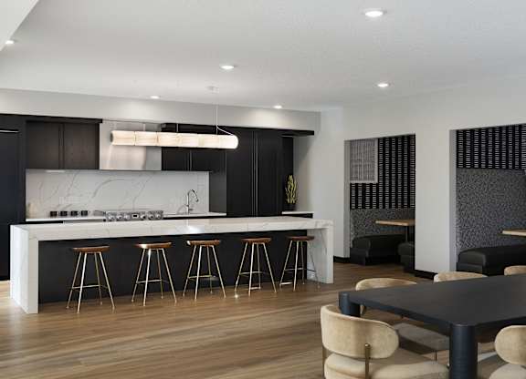 A modern kitchen with a bar area and a dining table.