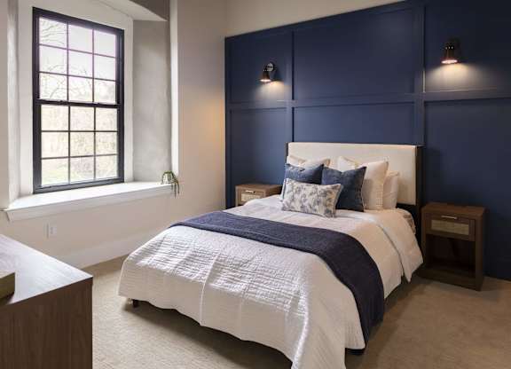 A bedroom with a large bed and a window at The Dean at Creekview Apartments, Newark, DE, 19711
