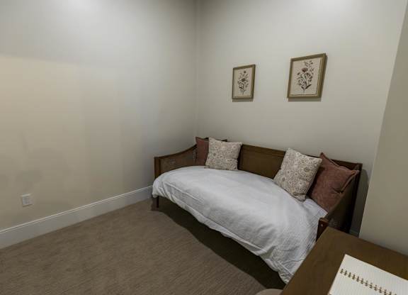 A bed with a white sheet and brown pillows in a room at The Dean at Creekview Apartments, Delaware, 19711