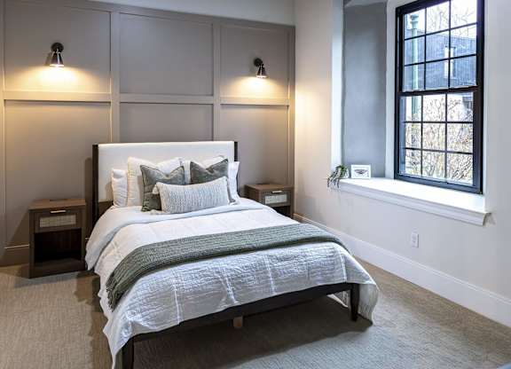 A bedroom with a large bed and a window at The Dean at Creekview Apartments, Newark, DE