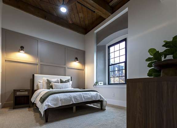 A bedroom with a large bed and a window at The Dean at Creekview Apartments, Newark, DE