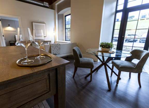 A dining table with two chairs and a tray with two glasses on it at The Dean at Creekview Apartments, Delaware, 19711