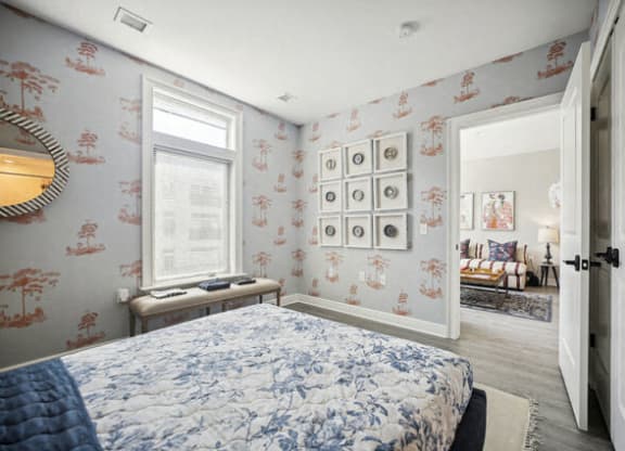 a bedroom with a bed and a wall of framed pictures at Park Kennedy, Washington, 20003