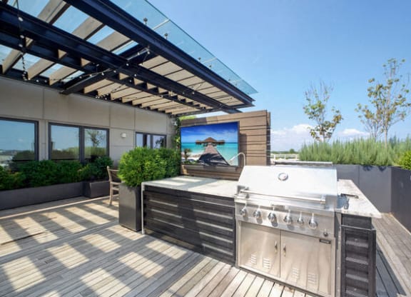 a large outdoor entertaining area with a grill and a television at Park Kennedy, Washington, 20003
