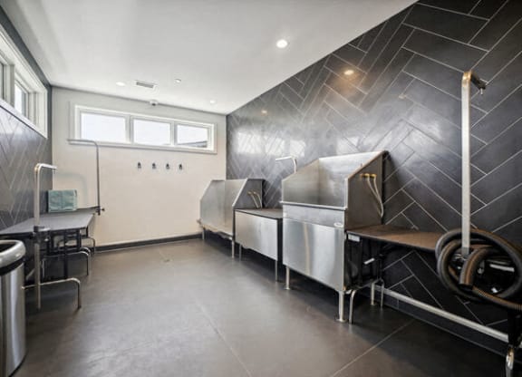 a kitchen with three stainless steel refrigerators and a table at Park Kennedy, Washington, DC
