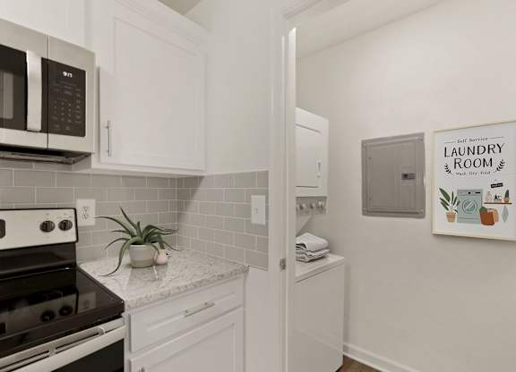 a kitchen with white cabinets and a stove and a microwave