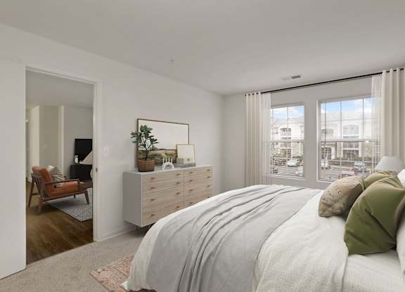 a bedroom with a bed and a dresser and a window at The Fields of Manassas