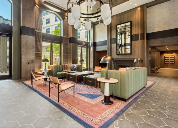 a lobby with couches and chairs and a large chandelier at Vyne One Loudoun, Ashburn