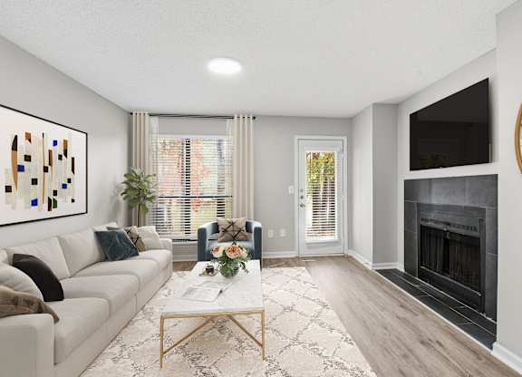 A modern living room with a fireplace and a large painting on the wall at Brampton Moors, Cary, NC, 27513