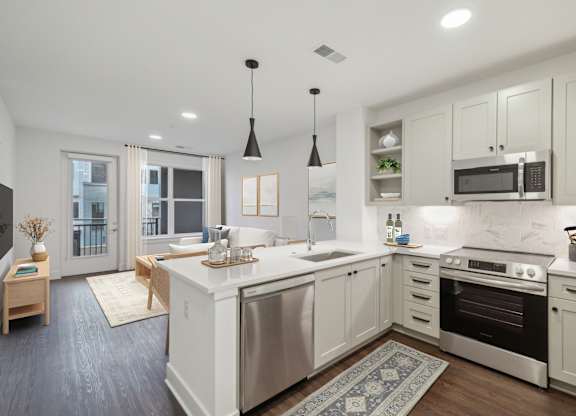 A modern kitchen with a large island and stainless steel appliances. at The Sully, Chantilly