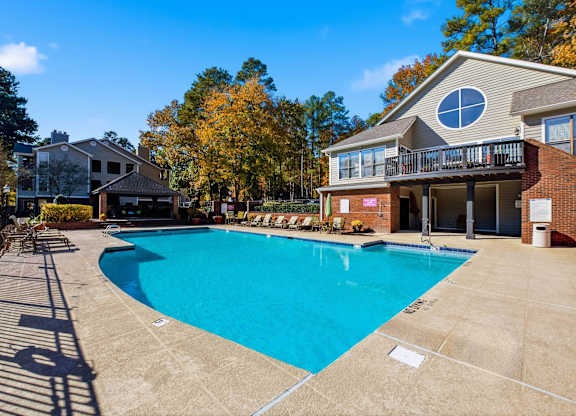 A large swimming pool in front of a house with a deck at Brampton Moors, Cary, NC, 27513