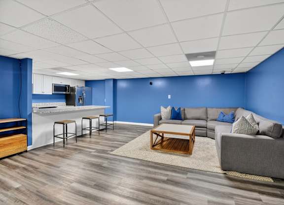 A living room with a grey couch and a wooden coffee table at Avondale Overlook, Hyattsville, 20782