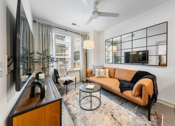a living room with a leather couch and a tv at Hawkins Press, Charlotte, NC, 28203