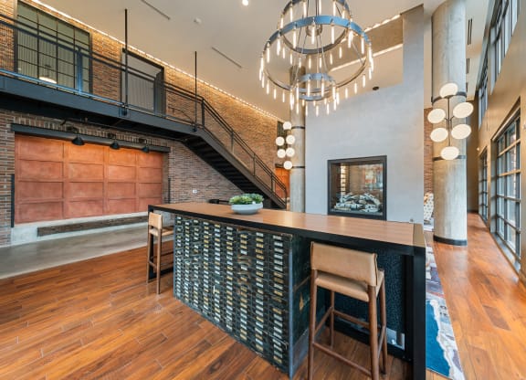 a kitchen with a long island and a chandelier at Hawkins Press Apartments North Carolina, NC